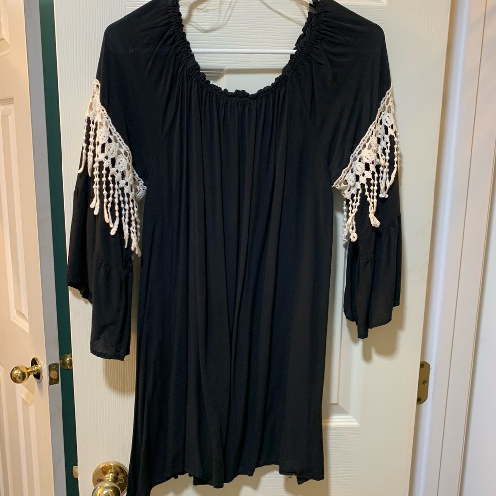 Black off the shoulder mini dress, with white details.